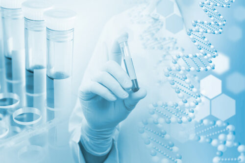 lab tech holding a vial.